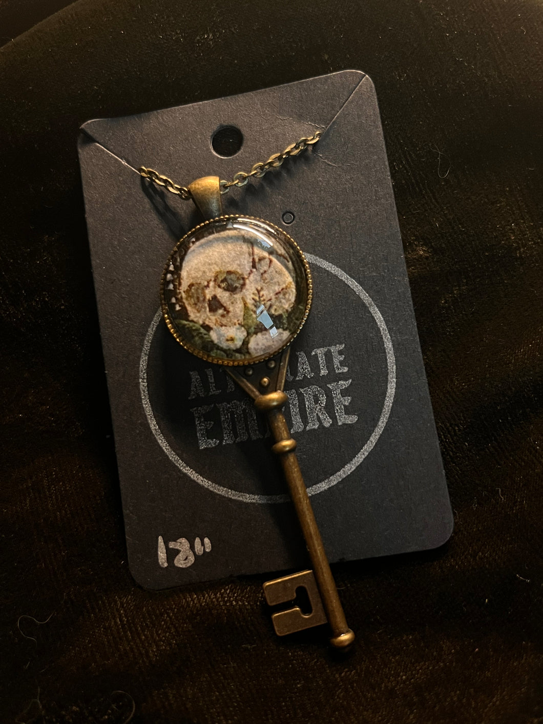 Skull and flower in brass key pendant